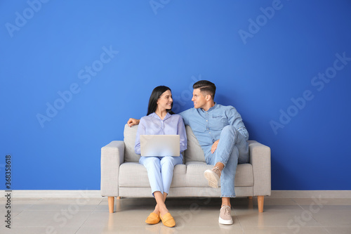 Young couple with laptop re...