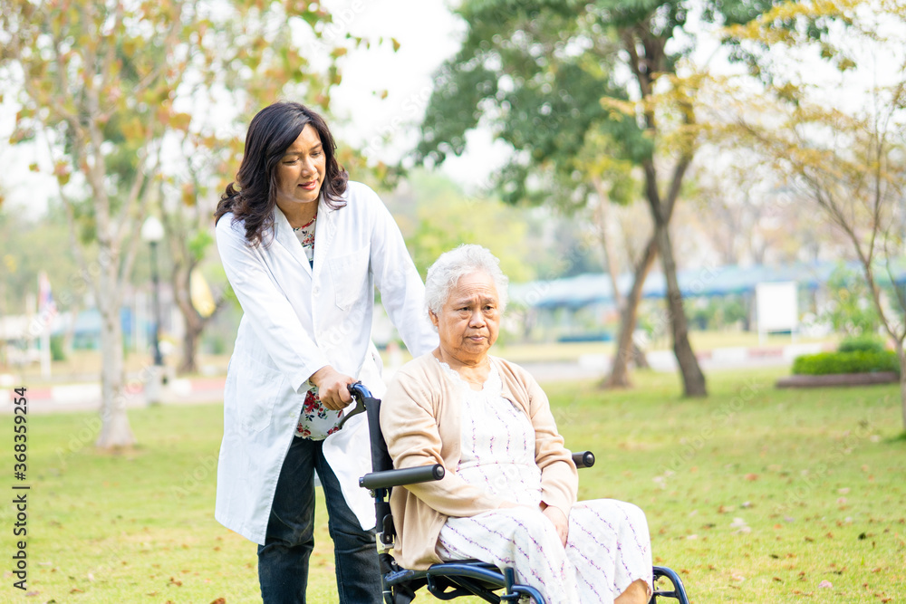 Doctor help and care Asian senior or elderly old lady woman patient sitting on wheelchair at nursing hospital ward, healthy strong medical concept Doctor help and care Asian senior or elderly old lady woman patient sitting on wheelchair at nursing hospital ward, healthy strong medical concept