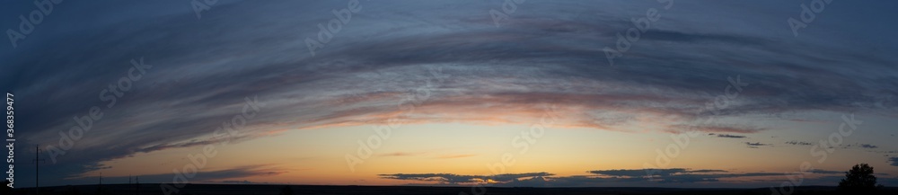 Epic landscape at sunset. Tragic gloomy sky. Fantastic skies on the planet earth. Crimson twilight. Panorama.