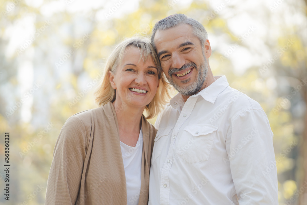 Elderly couple lifestyle concept. Husband embrace wife and sit on seat in the park relax on retirement life. Elderly couple lifestyle concept. Husband embrace wife and sit on seat in the park relax on retirement life.