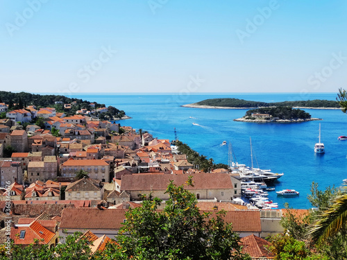 Aerial view of Hvar old city with port, old town, and island in Croatia. Hvar is a famous Croatian island for vacation. © isparklinglife