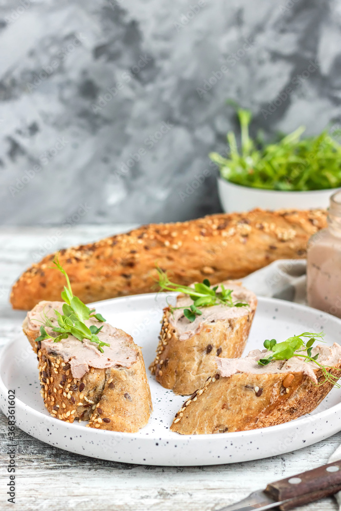 Turkey liver pate on whole grain baguette with microgreens
