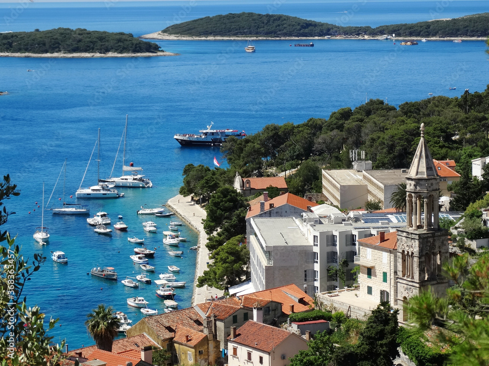 Aerial view of Hvar old city with port, old town, and island in Croatia. Hvar is a famous Croatian island for vacation.