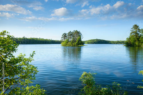 Fototapeta Naklejka Na Ścianę i Meble -  Beautiful blue lake with an island in northern Minnesota on a sunny afternoon