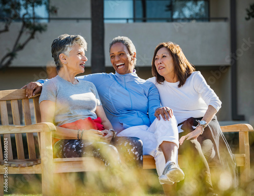 portrait of a senior citizen sitting on a bench photo