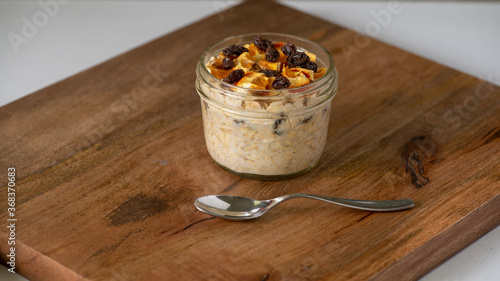 Εκτύπωση καμβά Dried oranges and raisins overnight oats on brown wooden board and a spoon, sele