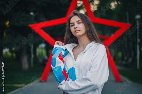 Young girl in oversize walking in city's park