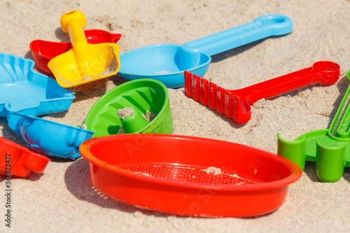 Children toys on sand at beach. Vacation time concept