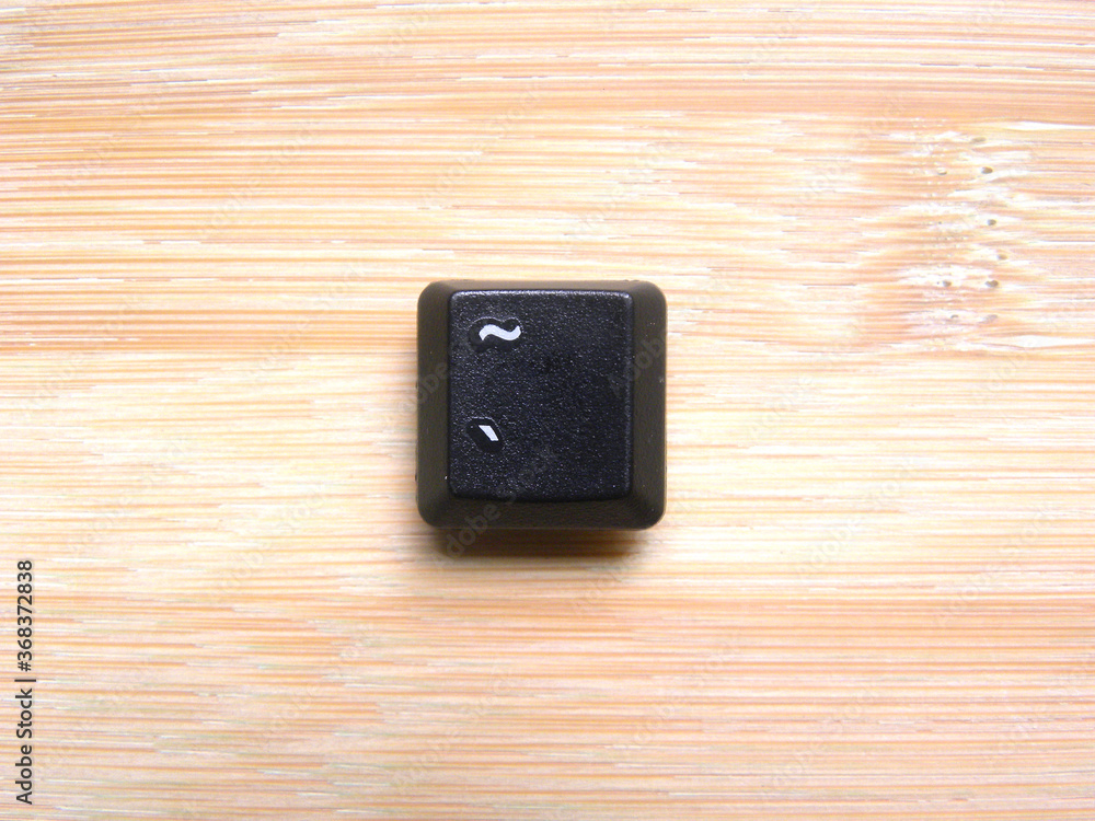 Black color Tilde key of computer keyboard Black color Tilde key of computer keyboard