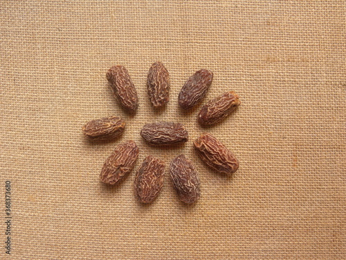 Brown color raw whole dried Dates photo