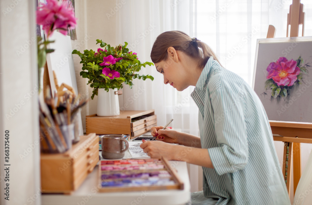 Side view of artist draws bouquet of rose and pink peony Side view of artist draws bouquet of rose and pink peony