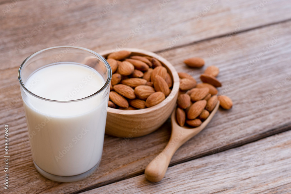 almonds nut and almond milk on wood table almonds nut and almond milk on wood table