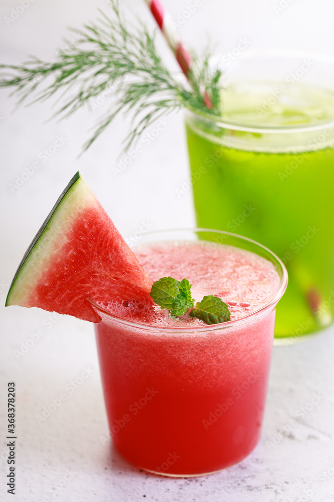 Red watermelon smoothie and green cocktail drink Red watermelon smoothie and green cocktail drink