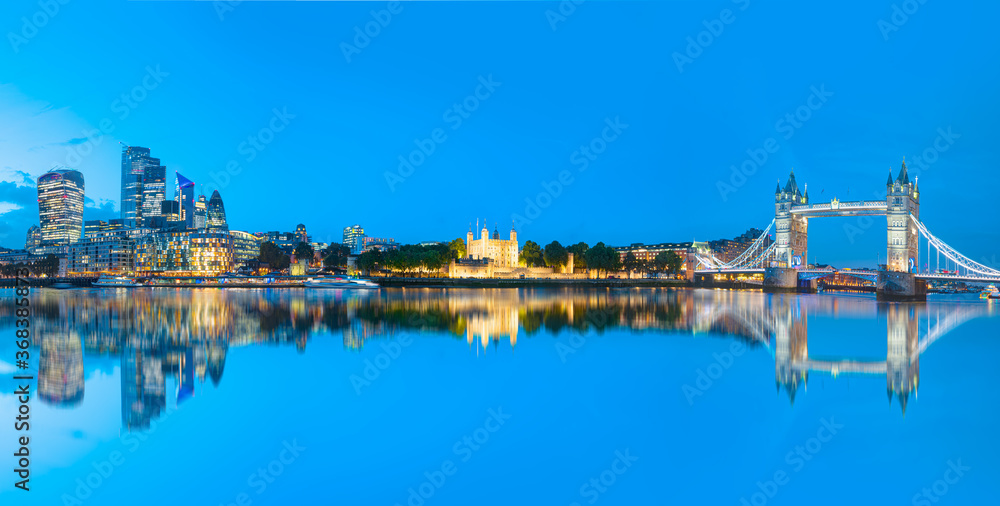 Naklejka premium Panorama of the Tower Bridge and Tower of London on Thames river at twilight blue hour - London England