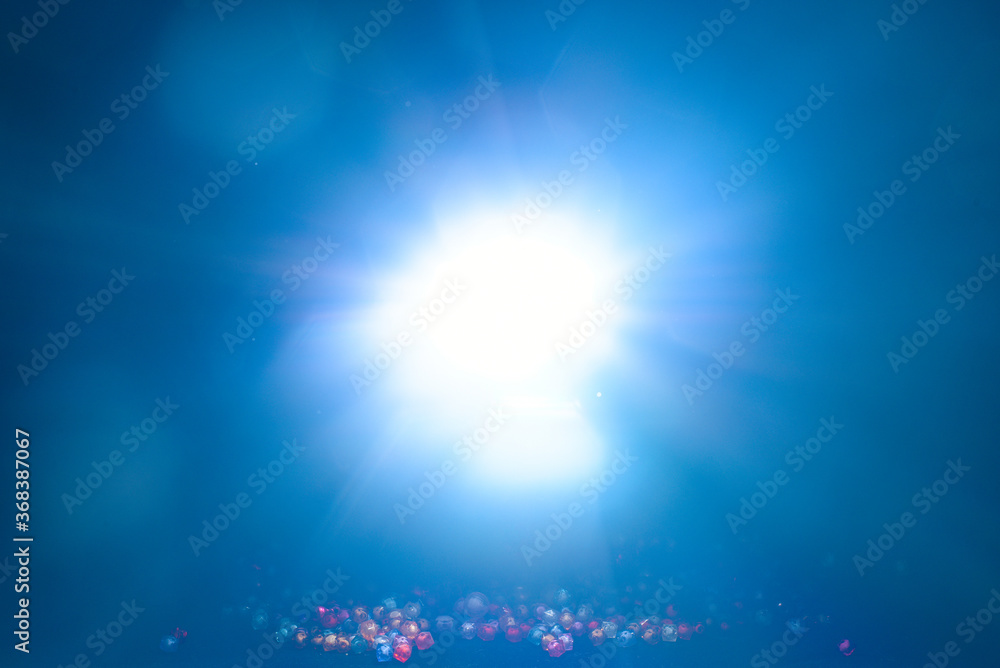 Blue light flare special effect and beads on black background , concert lighting . Blue light flare special effect and beads on black background , concert lighting .