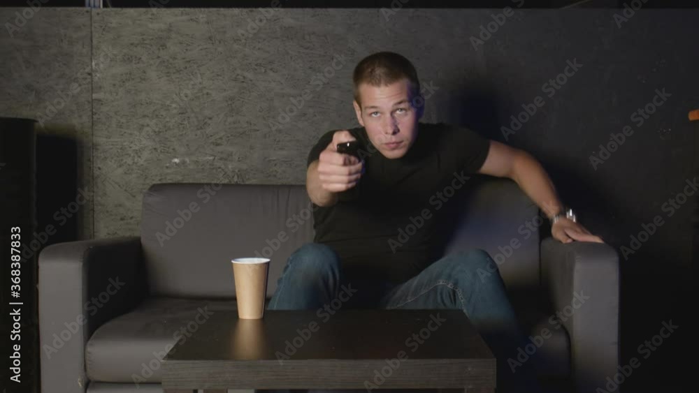 Young man turns off TV and leaves away Young man turns off TV and leaves away