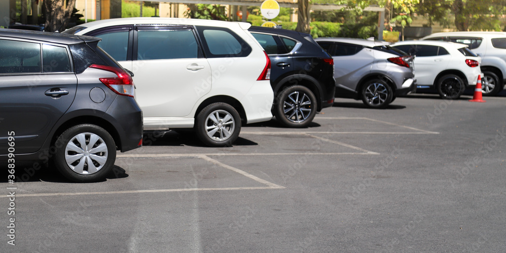 Closeup of rear, back side of black car with other cars parking in outdoor parking. Closeup of rear, back side of black car with other cars parking in outdoor parking.