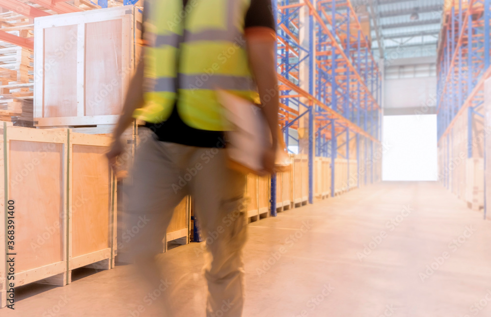 Blurred motion of warehouse worker in the warehouse. Cargo warehouse storage, Inventory management. Blurred motion of warehouse worker in the warehouse. Cargo warehouse storage, Inventory management.