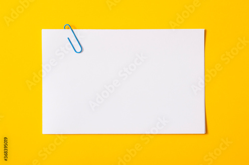 white sheet of paper for notes and paper clip
