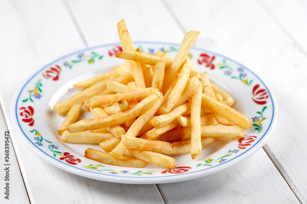 golden french fries on the wooden background golden french fries on the wooden background
