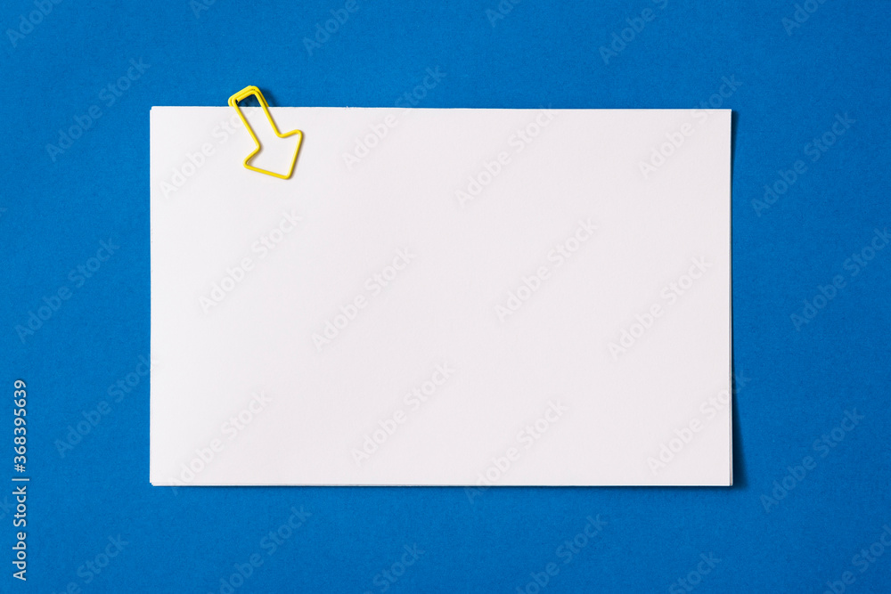 white sheet of paper for notes and paper clip
white sheet of paper for notes and paper clip