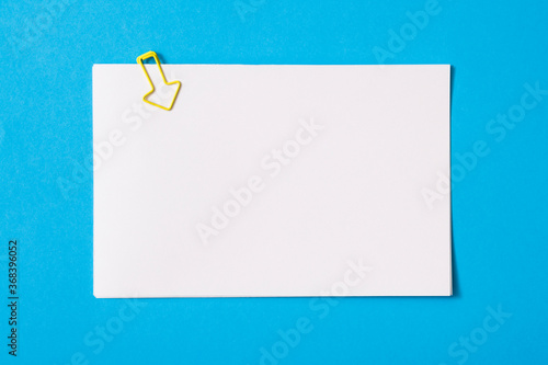 white sheet of paper for notes and paper clip 