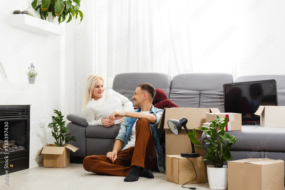 Young couple carrying big cardboard box at new home.Moving house. Young couple carrying big cardboard box at new home.Moving house.