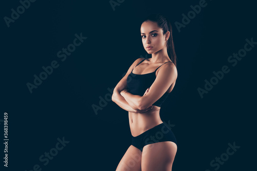 Profile side view portrait of her she nice-looking attractive adorable sportive gent taut prim strong lady folded arms perfect physical exercise energy style isolated over black background © deagreez