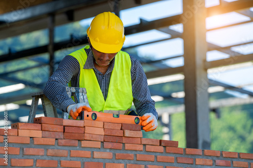 Bricklayer cement masonry build layer house worker,Concept of residential building under construction.