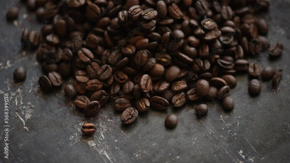Coffee beans on rustic black background from above. Coffee beans on rustic black background from above.