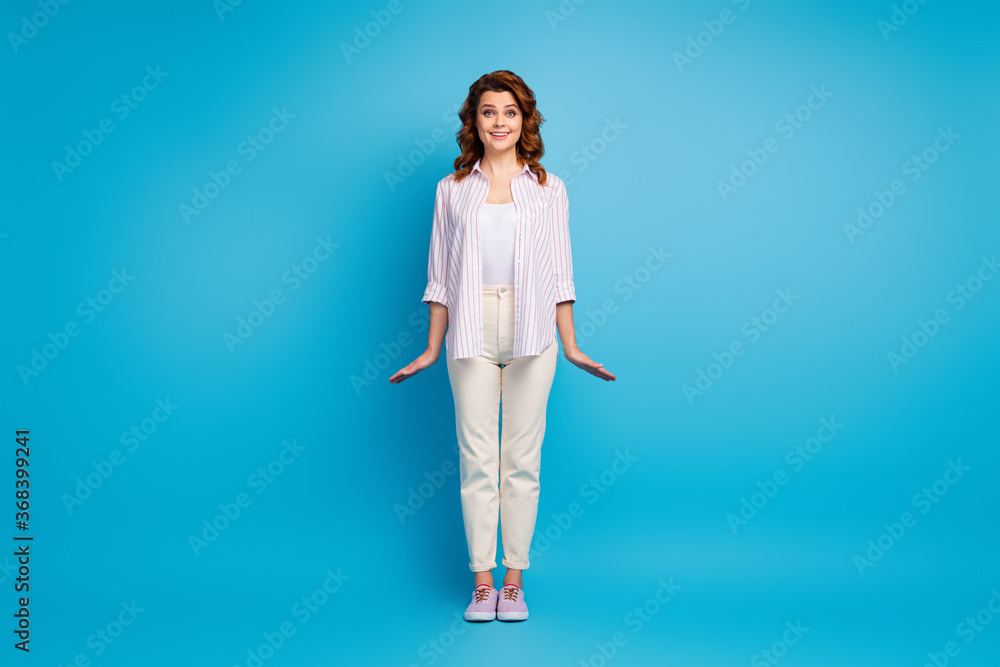 Full length body size view of her she nice attractive lovely cute pretty cheerful wavy-haired girl posing wearing casual clothing isolated on bright vivid shine vibrant blue color background Full length body size view of her she nice attractive lovely cute pretty cheerful wavy-haired girl posing wearing casual clothing isolated on bright vivid shine vibrant blue color background