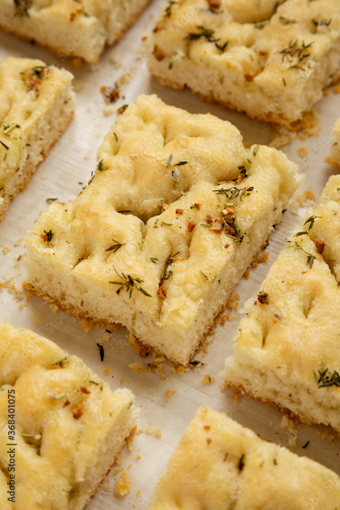 Home-baked Rosemary Garlic Focaccia Bread, low angle view. Close-up. Home-baked Rosemary Garlic Focaccia Bread, low angle view. Close-up.
