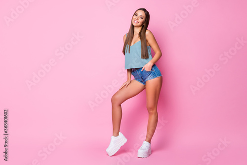 Full length body size view of nice attractive lovely lovable perfect charming pretty well-groomed fashionable thin cheerful cheery brown-haired girl posing isolated over pink pastel color background