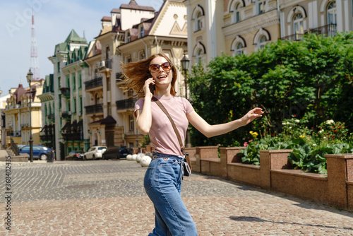 Beautiful Young Woman tourist in the City Center talking on the phone