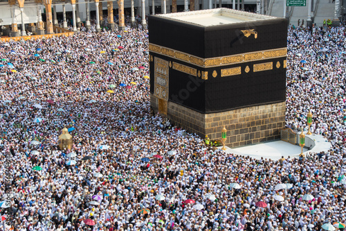 The Holy Kaaba. Crowd of people walking around Kaaba. Tawaf part during Umrah or Hajj