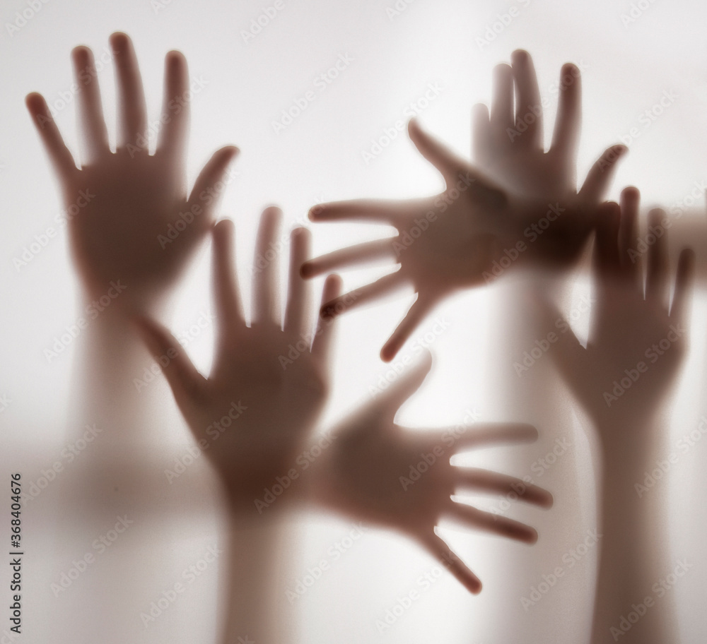 shadow of a hands behind transparent paper shadow of a hands behind transparent paper