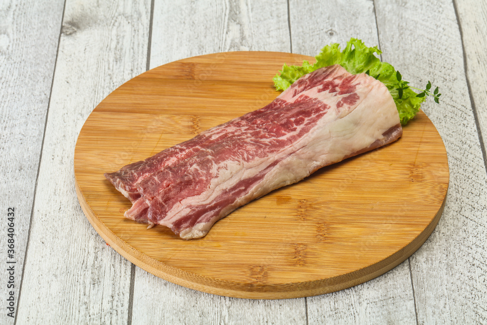 Raw beef bacon over wooden board Raw beef bacon over wooden board