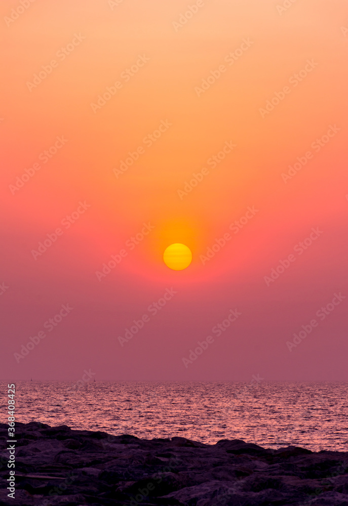 Sunset sky with sailing boat, golden hour click from Palm jumeira, Dubai, Dramatic sunset photography, travel concept image