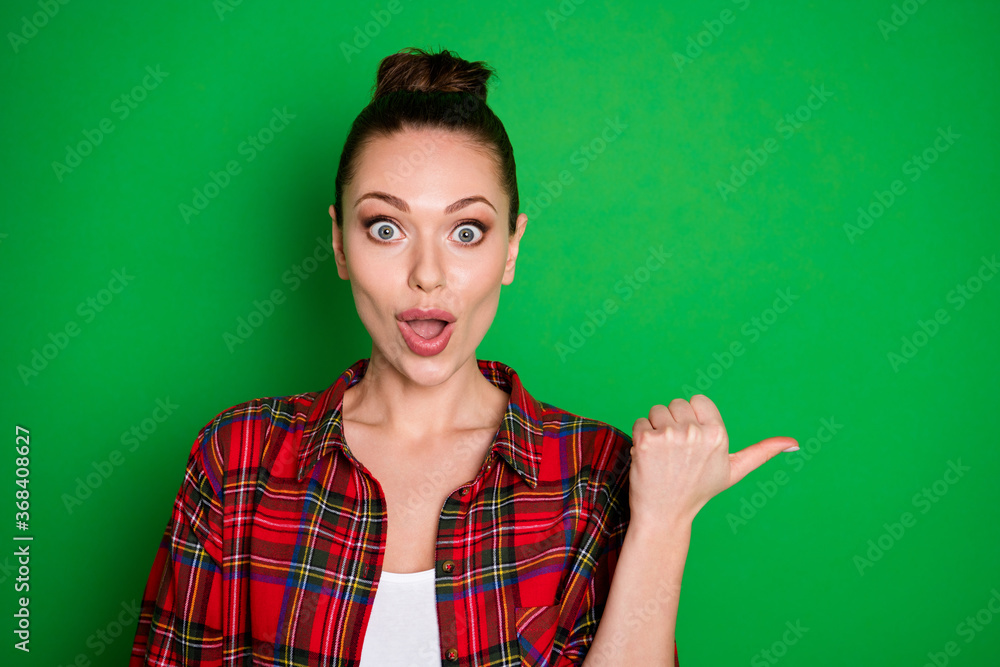 Close-up portrait of nice-looking attractive pretty amazed cheerful cheery girl in checked shirt showing good decision advert ad isolated on bright vivid shine vibrant green color background Close-up portrait of nice-looking attractive pretty amazed cheerful cheery girl in checked shirt showing good decision advert ad isolated on bright vivid shine vibrant green color background