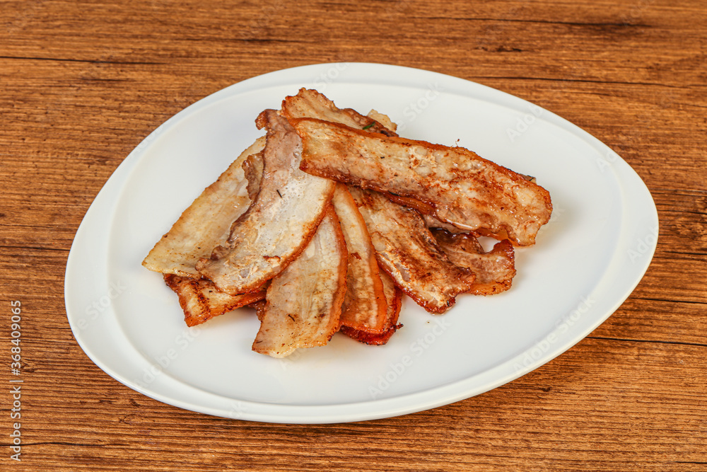 Roasted juicy bacon in the plate Roasted juicy bacon in the plate
