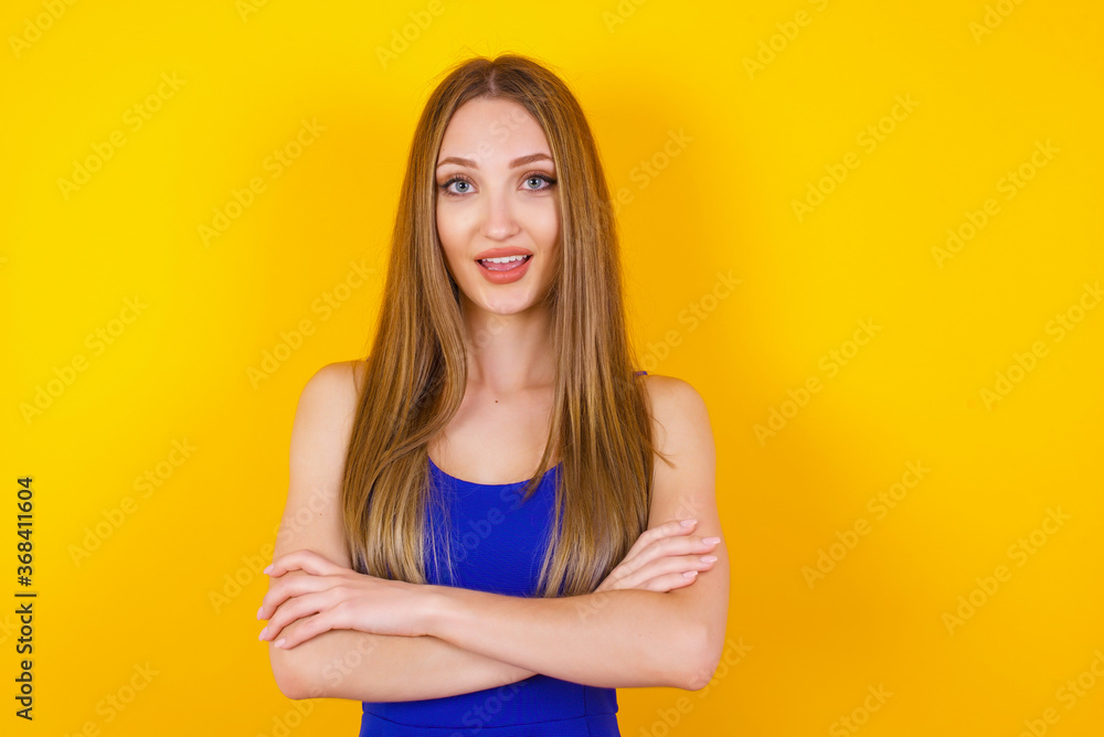 Brunette girl happy face smiling with crossed arms looking confident at the camera standing against gray wall. Positive person. Brunette girl happy face smiling with crossed arms looking confident at the camera standing against gray wall. Positive person.