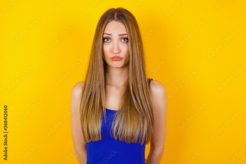 Beautiful face of sad woman crying desperate and depressed with tears on her eyes suffering pain and depression isolated on grey background in sadness facial expression and emotion concept. Beautiful face of sad woman crying desperate and depressed with tears on her eyes suffering pain and depression isolated on grey background in sadness facial expression and emotion concept.