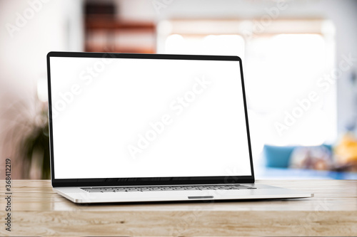 Laptop with blank screen on wooden table	