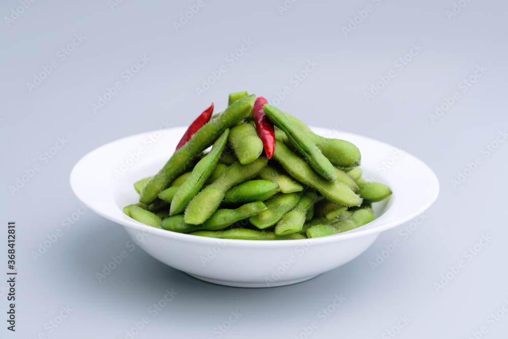 A traditional Chinese delicacy in solid color, boiled soybeans in brine. Chinese traditional food boiled soybean A traditional Chinese delicacy in solid color, boiled soybeans in brine. Chinese traditional food boiled soybean