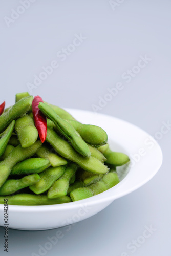 A traditional Chinese delicacy in solid color, boiled soybeans in brine. Chinese traditional food boiled soybean