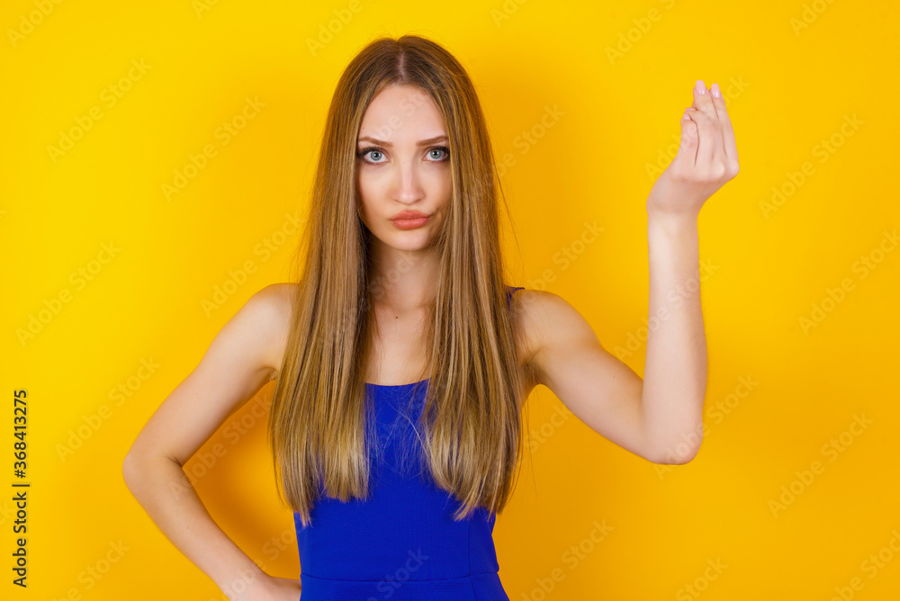 What the hell are you talking about. Shot of frustrated young European woman gesturing with raised hand doing Italian gesture, frowning, being displeased and confused with dumb question. What the hell are you talking about. Shot of frustrated young European woman gesturing with raised hand doing Italian gesture, frowning, being displeased and confused with dumb question.