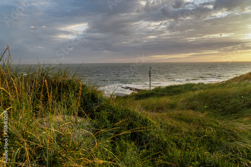 Photograph at the beach and dunes moments before the sun sets in the southwest of the Netherlands. 