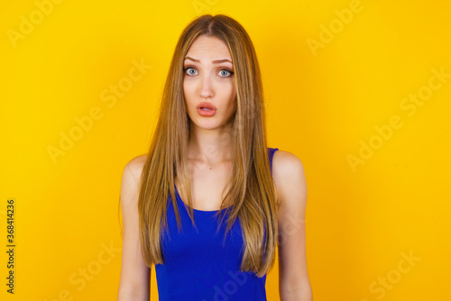 Brunette woman in casual clothes expressing disgust, unwillingness, dislike, disregard having tensive look frowning face. Cauasian woman with pleasant appearance looking indignant digusting something
