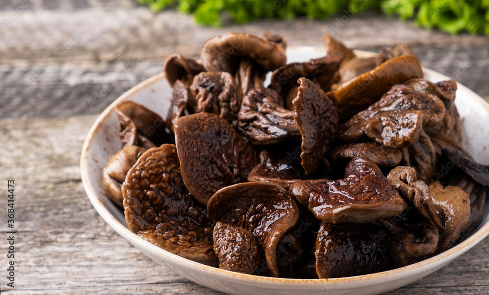 Boild white mushrooms. Tasty mushrooms on a plate Boild white mushrooms. Tasty mushrooms on a plate