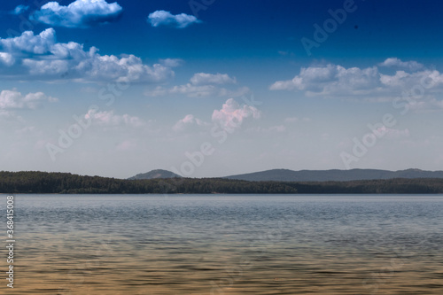 View of the opposite shore of the lake in the afternoon.